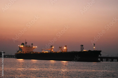 merchant ship is offloading in the evening