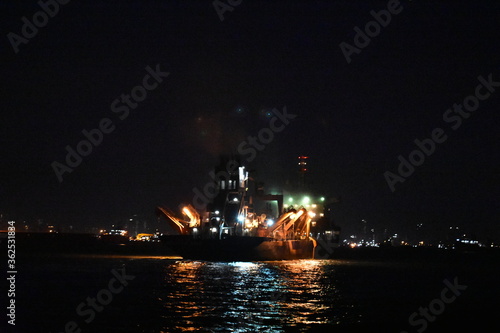 a ship captured in night,full of colorful lights.