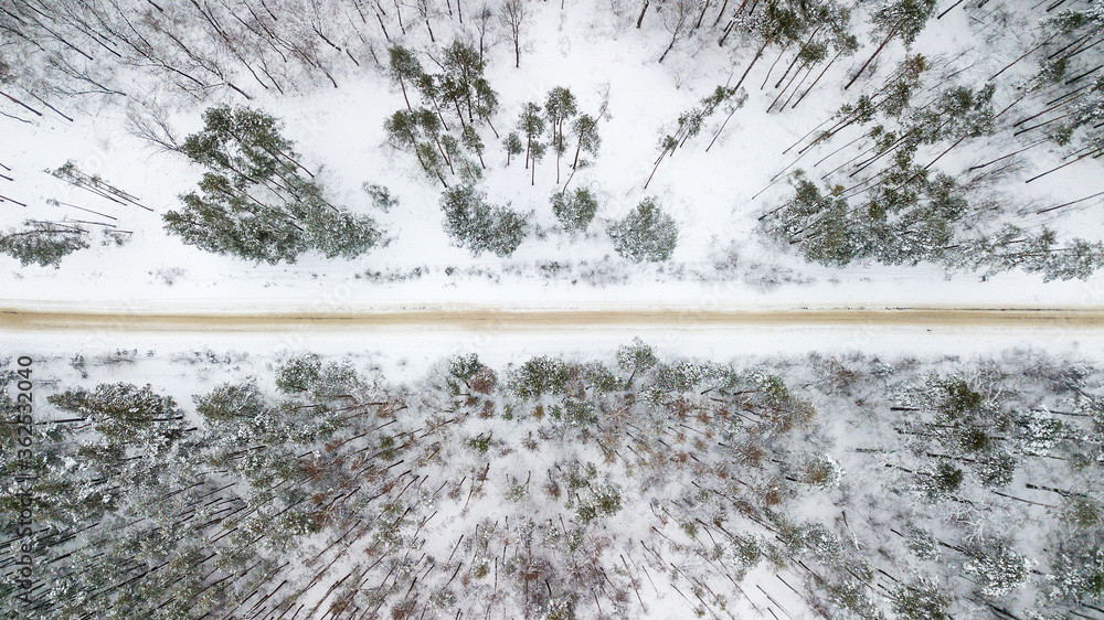 Aerial view of the road with snow in the forest Aerial view of the road with snow in the forest