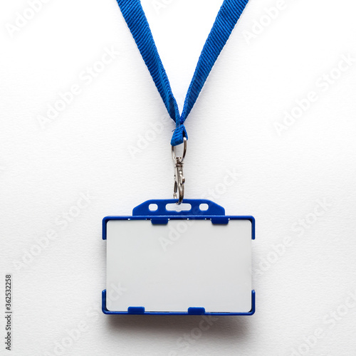 Blank name tag or identification badge on blue strap. White background