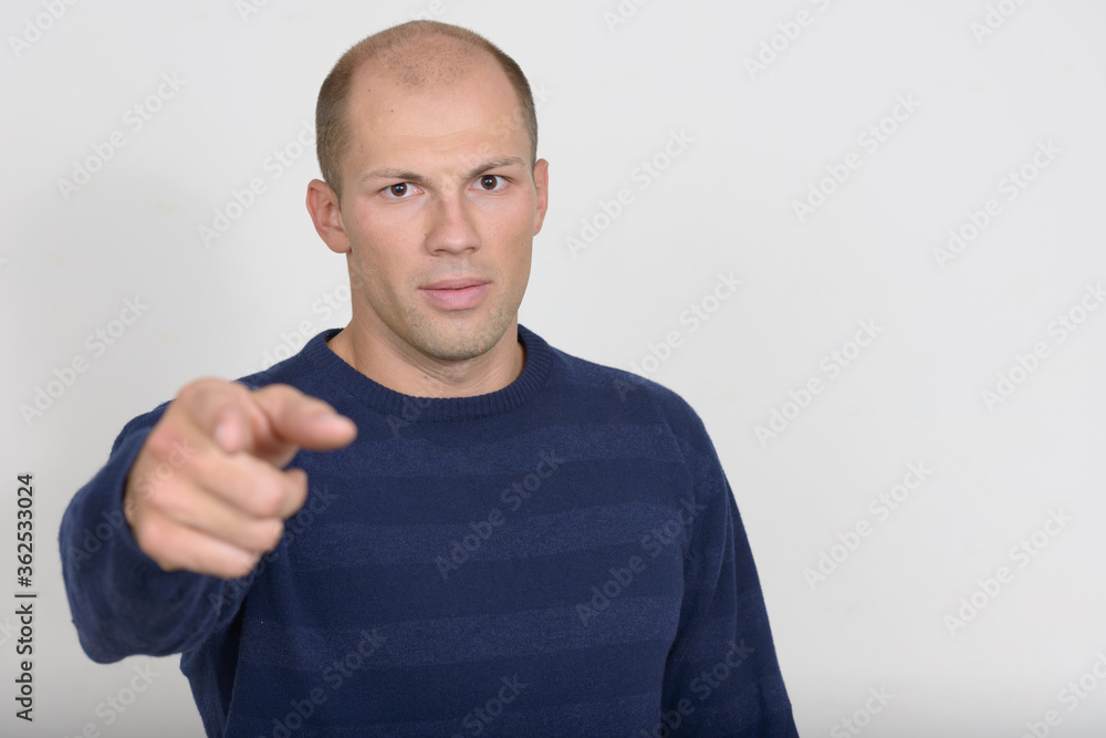 Portrait of young handsome bald man pointing at camera Portrait of young handsome bald man pointing at camera