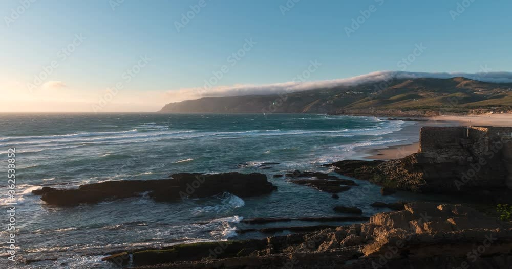 Time lapse of the beautiful Guincho Beach (Praia do Guincho) in Cascais, Portugal, at sunset Time lapse of the beautiful Guincho Beach (Praia do Guincho) in Cascais, Portugal, at sunset