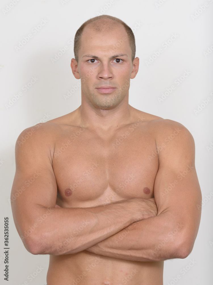 Young handsome muscular bald man with arms crossed shirtless Young handsome muscular bald man with arms crossed shirtless