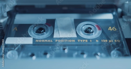 Close up of audio cassette tape playing in stereo / tape recorder photo