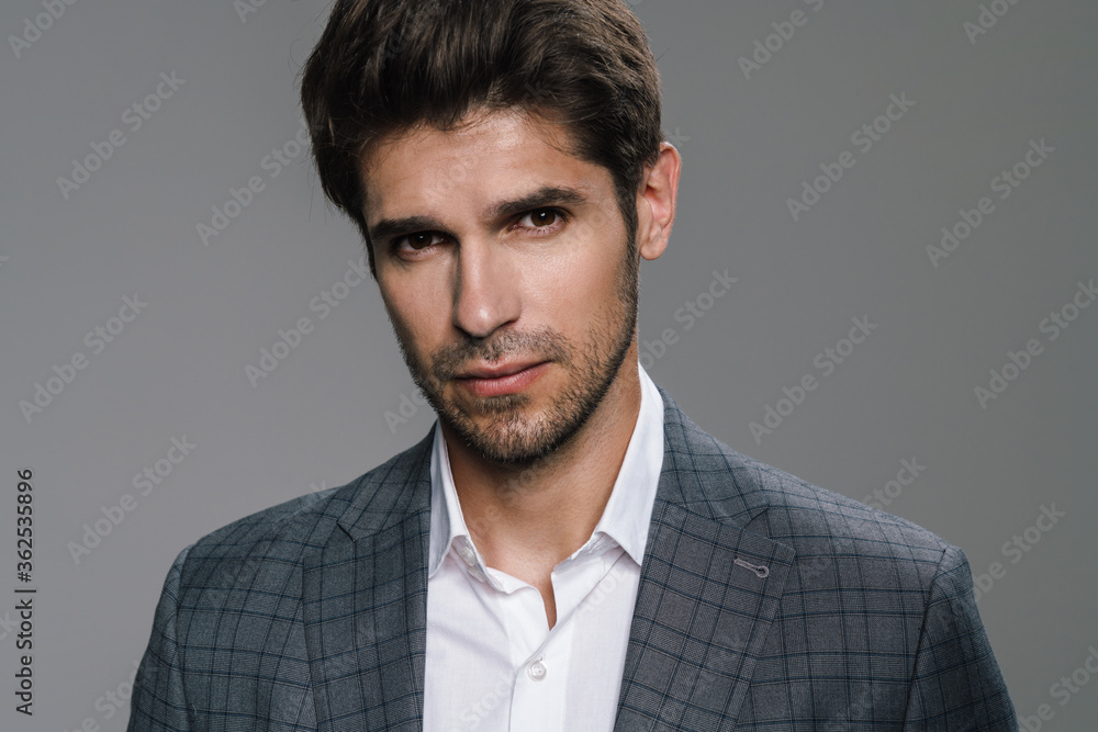 Photo of respectable confident businessman posing and looking at camera Photo of respectable confident businessman posing and looking at camera