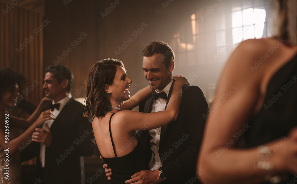 Smiling couples dancing at party Smiling couples dancing at party