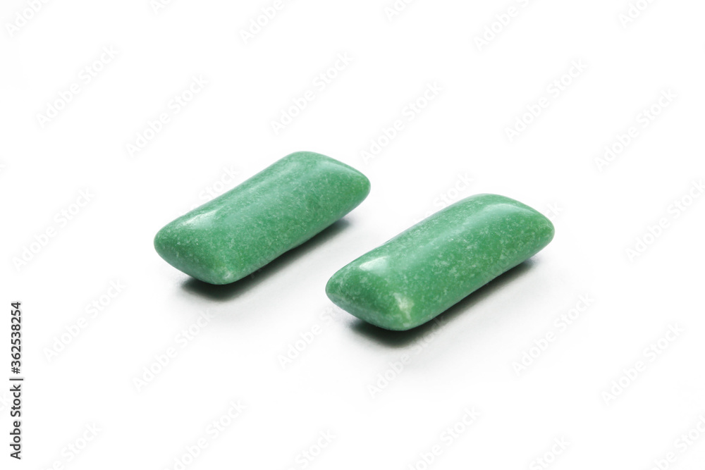 Two green mints isolated on white background. Sweet Chewing gums close-up Two green mints isolated on white background. Sweet Chewing gums close-up