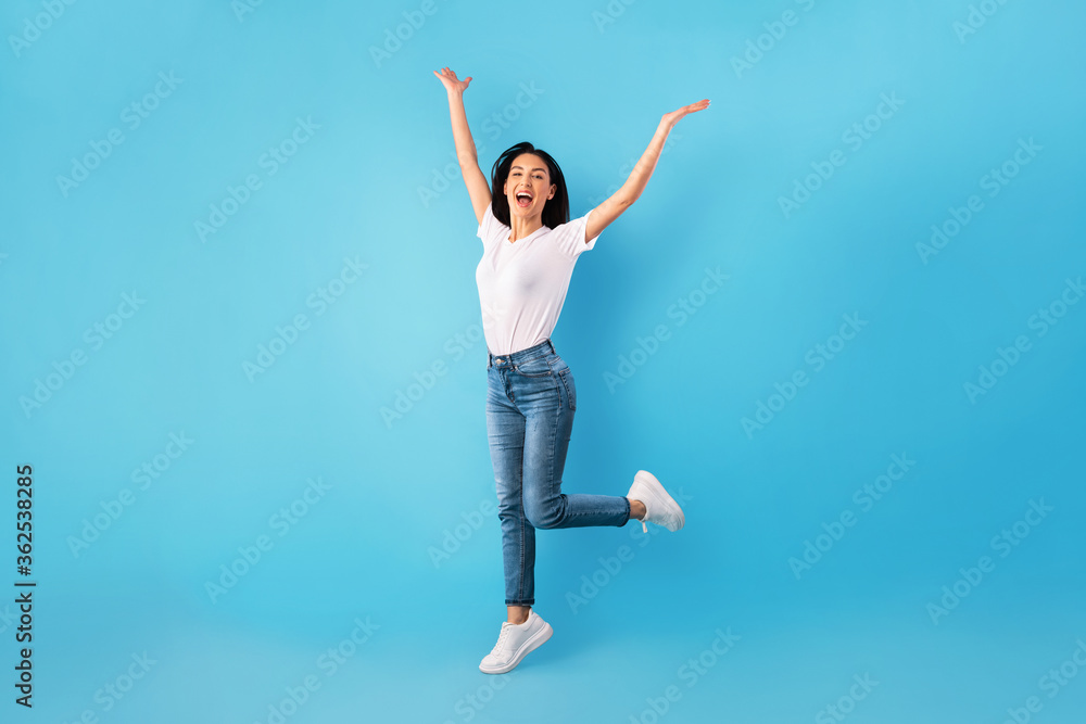 Happy lady jumping and looking at camera