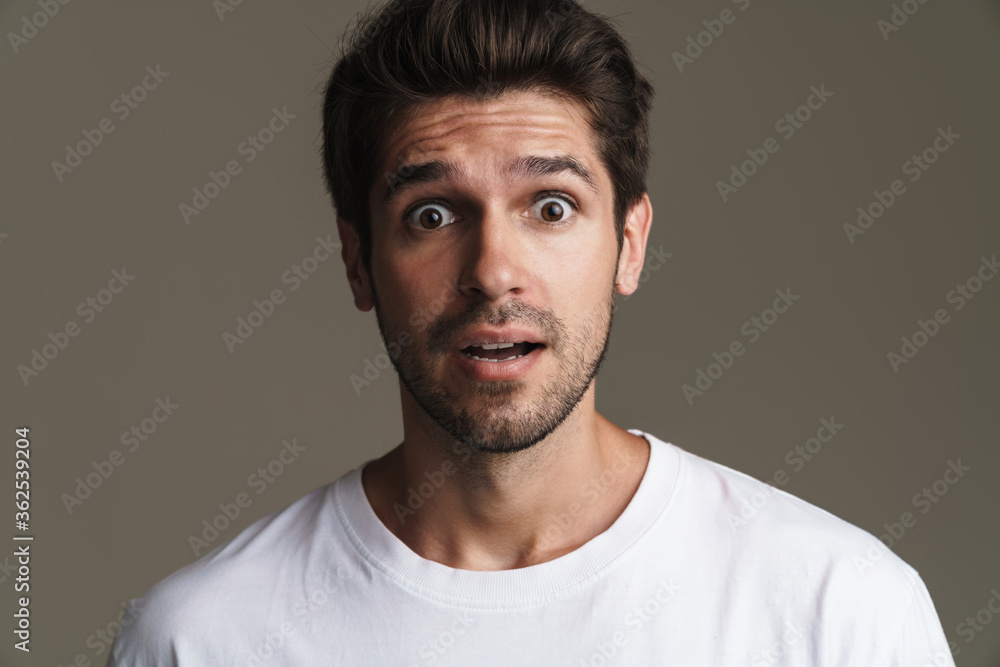 Fototapeta premium Portrait of shocked young man expressing surprise on camera