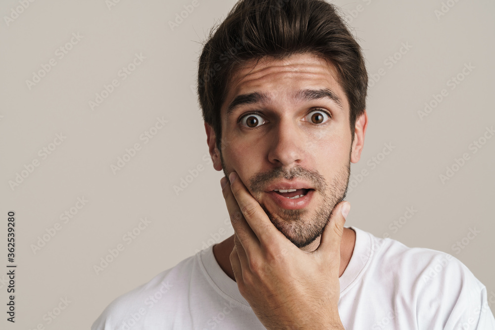 Portrait of shocked young man expressing surprise on camera