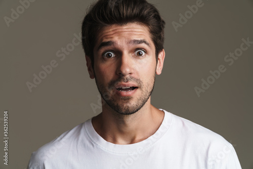 Portrait of shocked young man expressing surprise on camera