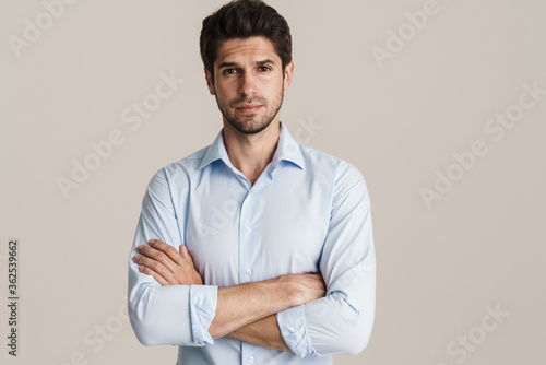 Portrait of unshaven confident man posing and looking at camera