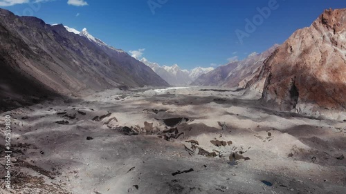 Close aerial view of the Batura glacier morraine with its 57 km length, located near the Hunza valley, surrounded by arid mountains and snowy peaks in the background, Gilgit Baltistan region, Pakistan