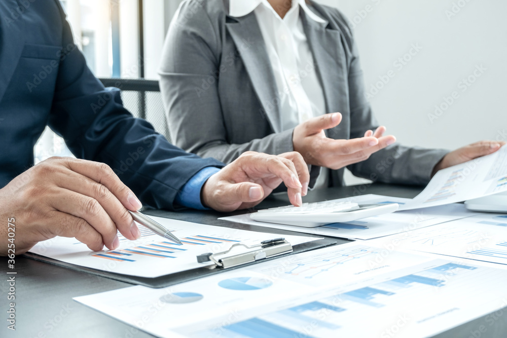 Two business leaders talk about charts, financial graphs showing results are analyzing and calculating planning strategies, business success building processes Two business leaders talk about charts, financial graphs showing results are analyzing and calculating planning strategies, business success building processes