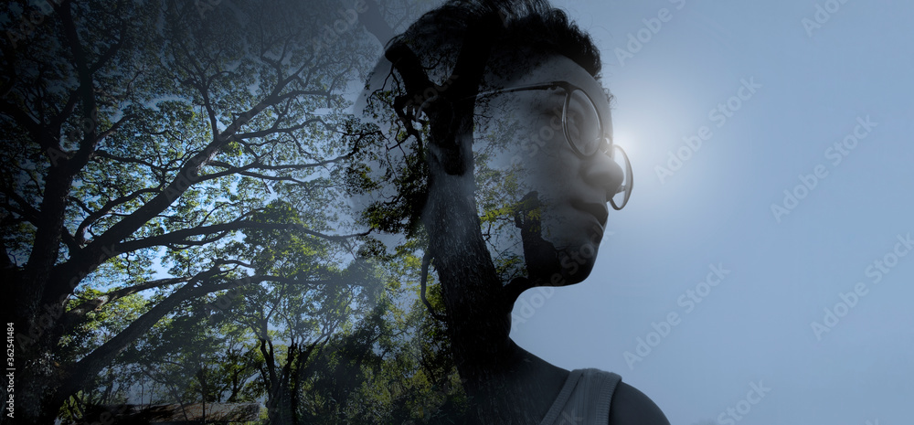 Young attractive female with dark skin thinking and combines with the natural beauty and forest as mental health concept. Young attractive female with dark skin thinking and combines with the natural beauty and forest as mental health concept.