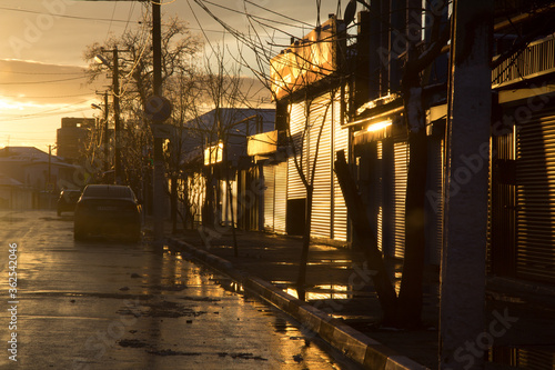 Fototapeta Naklejka Na Ścianę i Meble -  Empty street after rain at sunset
