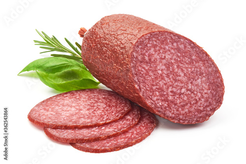 Dried Salami Sausage with basil, close-up, isolated on a white background