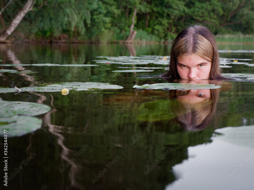 mermaid girl in the water among water lilies at sunset mermaid girl in the water among water lilies at sunset