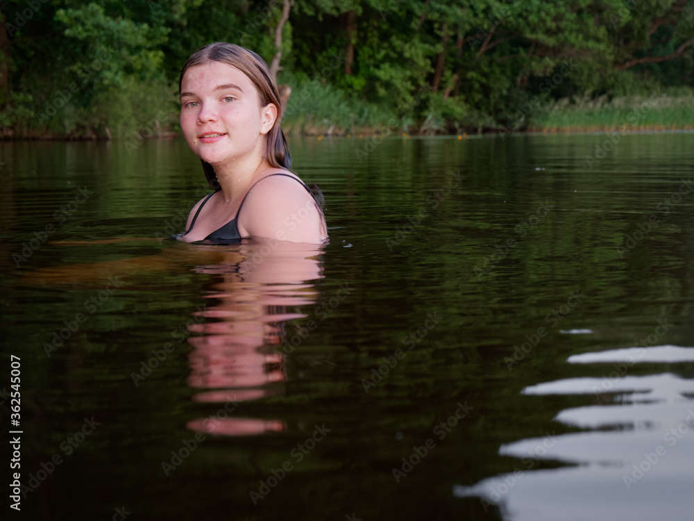 mermaid girl in the water among water lilies at sunset mermaid girl in the water among water lilies at sunset