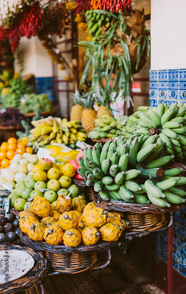 Funchal - Madeira, 20.09.2019. Exotic fruits at the farmers market. Green bananas, pineapples, dragon fruit.
