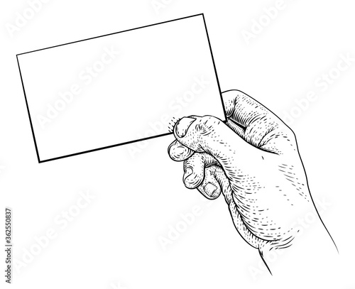 A hand holding a business card, letter, message, flyer or similar with copyspace in a vintage engraved or etched woodcut print style