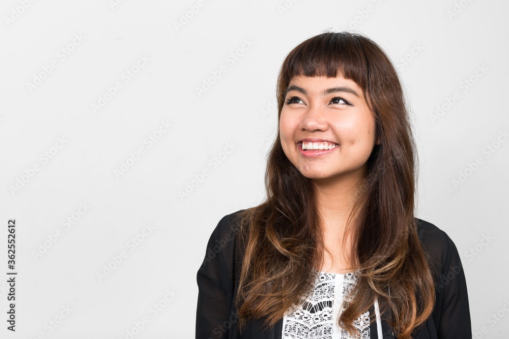 Portrait of happy young beautiful Asian woman thinking Portrait of happy young beautiful Asian woman thinking