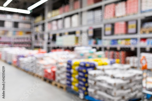 Canvastavla blurred background of a hardware store with bags of cement