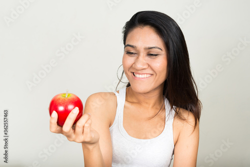 Portrait of happy Asian woman holding apple
