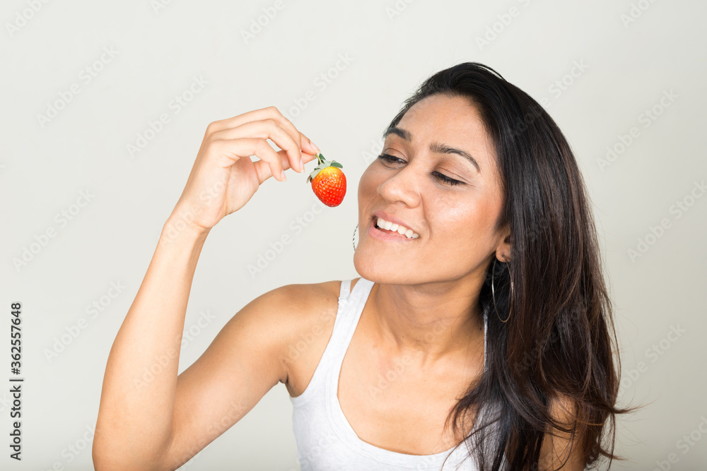 Portrait of happy Asian woman eating strawberry Portrait of happy Asian woman eating strawberry