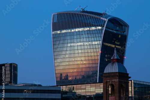 Cityscape in blue hours, 20 Fenchurch Street Walkie Talkie building  reflecting the sun and the skyscrapers. Photo taken from the South Bank photo