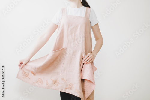 Girl wearing Japanese linen apron. Cooking at home. Kitchen textile. linen fabric 