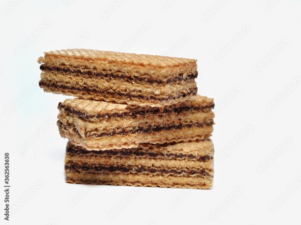 Vanilla wafers isolated on white background. Wafers filled with chocolate and vanilla cream. Crunchy dessert. Vanilla wafers isolated on white background. Wafers filled with chocolate and vanilla cream. Crunchy dessert.