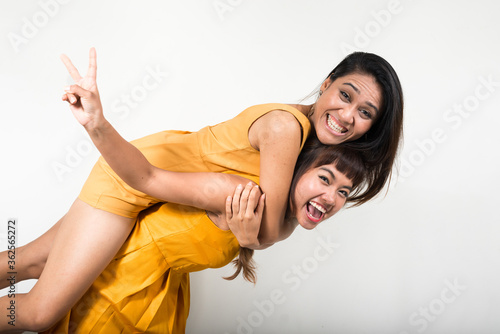 Portrait of two happy young Asian women together