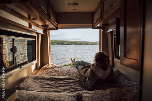 The girls is enjoying a view from the campervan bed on Cape Breton Island Fototapet