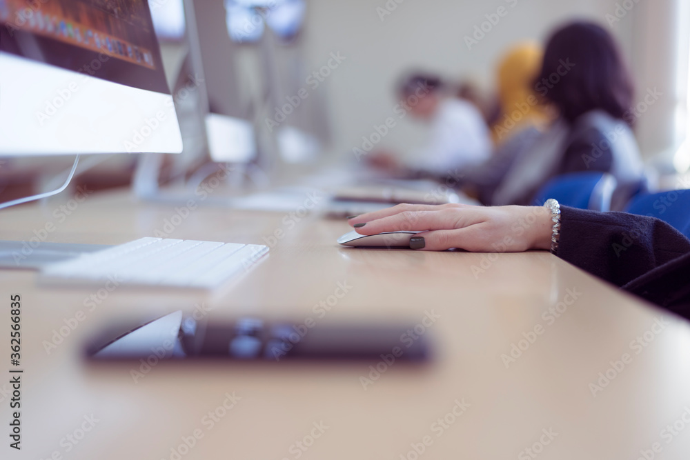 College students sitting in a classroom, using laptop computers during class listening lesson about covid19  virus