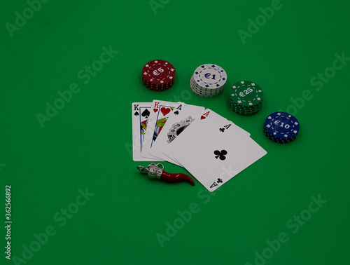 Poker cards and amulete on a green table photo