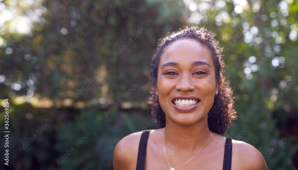 Outdoor Portrait Of Smiling African American Woman At Home Relaxing At Garden Party Outdoor Portrait Of Smiling African American Woman At Home Relaxing At Garden Party
