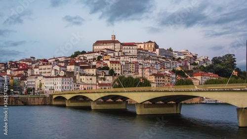 Coimbra, Portugal, zoom out timelapse view of the former Portuguese capital including historical landmark University of Coimbra and Santa Clara bridge over the Mondego River. photo