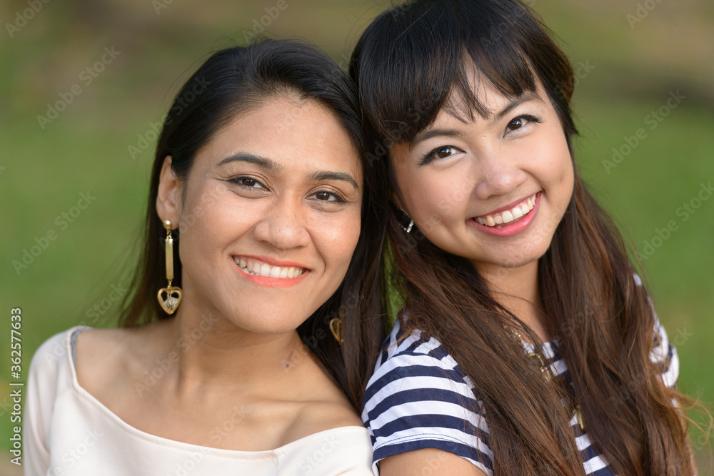 Portrait of two happy young Asian women together at the park Portrait of two happy young Asian women together at the park