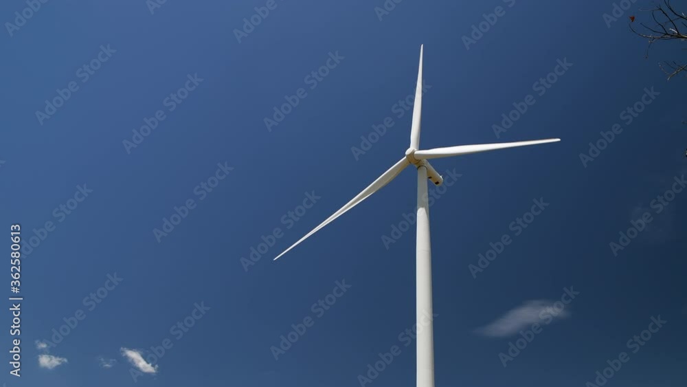 Big Windmills for electric power production on blue sky at Huai Bong, Dan Khun Thot district, Nakhon Ratchasima THAILAND. renewable energy and save environmental concept. Big Windmills for electric power production on blue sky at Huai Bong, Dan Khun Thot district, Nakhon Ratchasima THAILAND. renewable energy and save environmental concept.