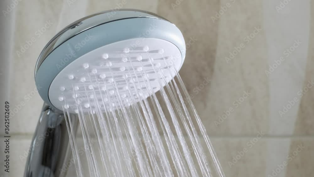 Go shower in Bathroom. Opening a water in shower that starts running