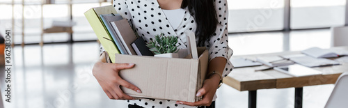 panoramic crop of dismissed manager holding box with folders and documents