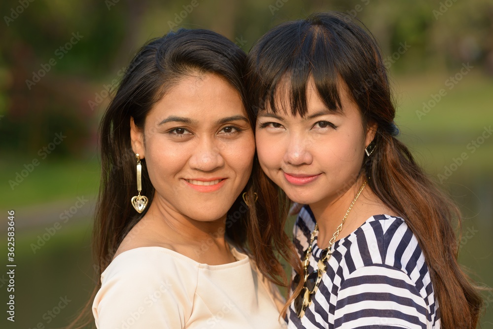 Portrait of two young Asian women together at the park Portrait of two young Asian women together at the park