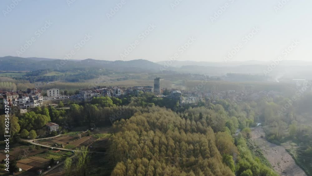 Aerial shot of the Hostalric town in Catalonia in a gentle embrace of a heavenly and lush nature. Aerial shot of the Hostalric town in Catalonia in a gentle embrace of a heavenly and lush nature.