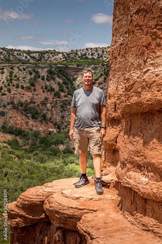Man standing on the edge of the Lighthouse Rock, Palo Duro Canyin State Park, Texas