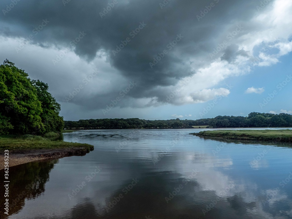 storm clouds gathering over the river