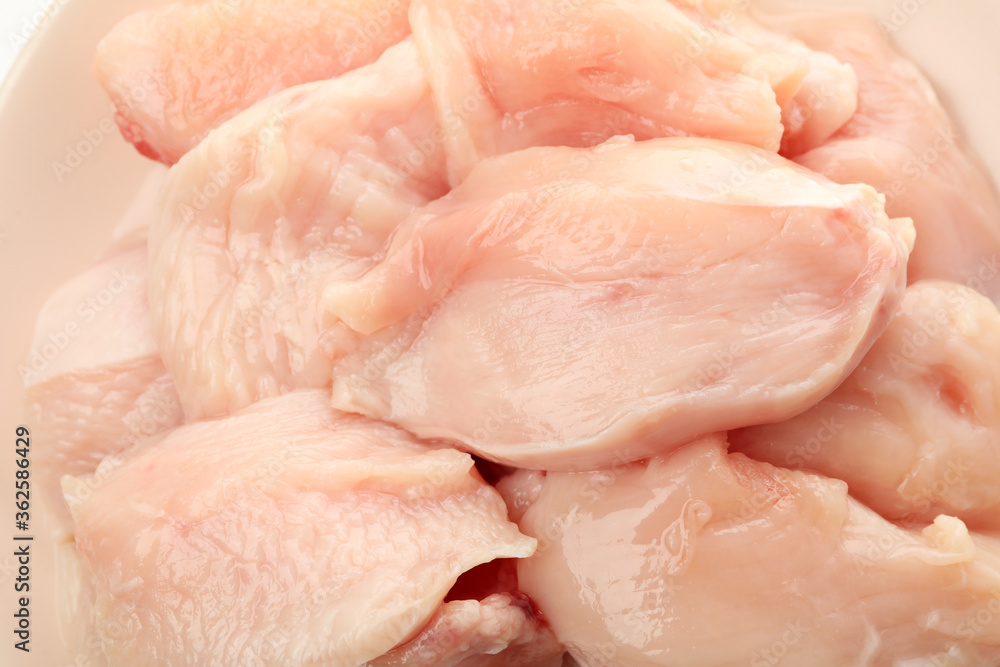 Raw chicken meat on whole background, close up Raw chicken meat on whole background, close up