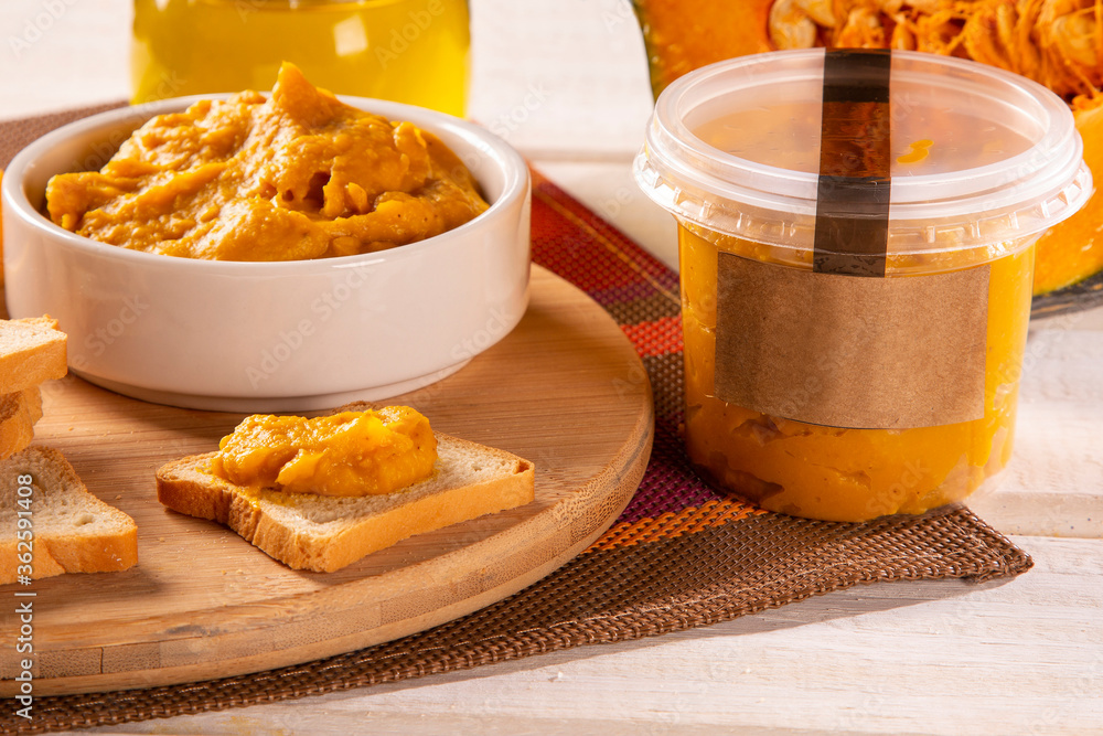 Pumpkin puree or hummus on a rustic wooden table. Selective focus Pumpkin puree or hummus on a rustic wooden table. Selective focus