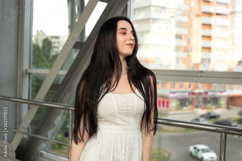 Portrait of a beautiful brunette in a light dress on the street in a pedestrian crossing on a summer day Free Download Portrait of a beautiful brunette in a light dress on the street in a pedestrian crossing on a summer day - GFXLoad