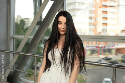 Portrait of a beautiful brunette in a light dress on the street in a pedestrian crossing on a summer day Free Download Portrait of a beautiful brunette in a light dress on the street in a pedestrian crossing on a summer day - GFXLoad